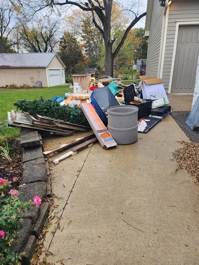 Dumpster being loaded with debris for Demolition Dumpster Rental in Waunakee